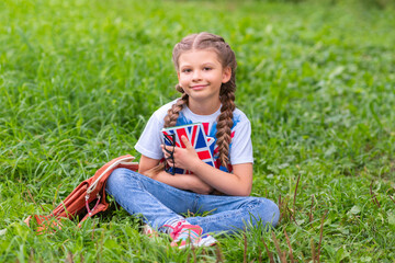 A little girl on school holidays repeats school material in English.