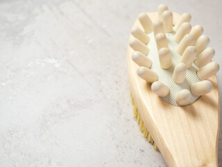 on a concrete background accessories for spa treatments, brushes for face and body massage,