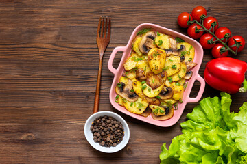 Rustic potatoes in a frying pan with different seasonings and spices.
