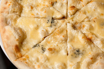 Four cheese pizza quattro formaggi close up photo.