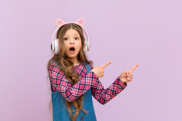 A girl with headphones is pointing at your ad on an isolated background.