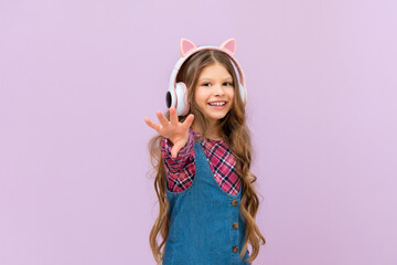 Children's beautiful headphones on a little girl on an isolated background.