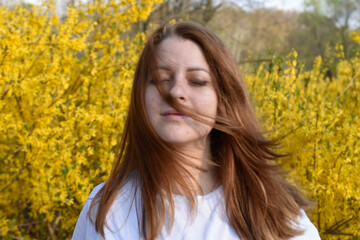 Portret of woman in white shirt on yellow background