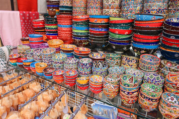 Colorful east ceramic plates and bowls with national pattern in colorful colors. National tableware on Traditional market in Dubai, UAEz. High quality photo