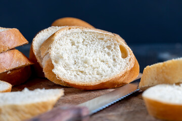 wheat baguette cut into pieces on a cutting board
