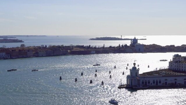 Venice Italy elevated day view of Dorsoduro district with Punta della Dogana visible on Grand Canal and Giudecca island with Church of the Santissimo Redentore in the background.