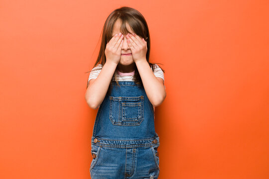 Scared little girl with eyes covered