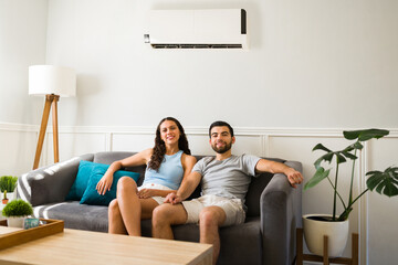 Attractive couple with an ac unit at home