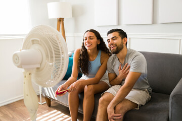 Beautiful couple cooling down in front of the fan