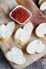 red salmon or trout caviar with white baguette and butter