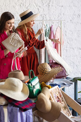 Young women at swap home party - clothes, shoes, bags, jewellery exchange between friends. Zero...