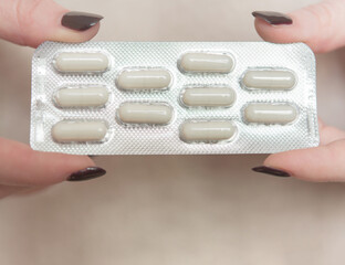  woman's hands with pills and medications