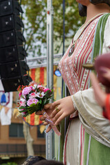 Giants and big heads. Traditional festival in Badalona, Barcelona, Spain. Detail of hand fence with bouquet of flowers.