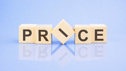 PRICE - word is written on wooden cubes on a blue background. close-up of wooden elements
