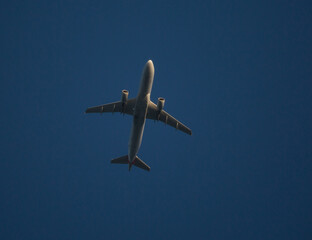 Commercial Airliner Overhead with Deep Blue Sky