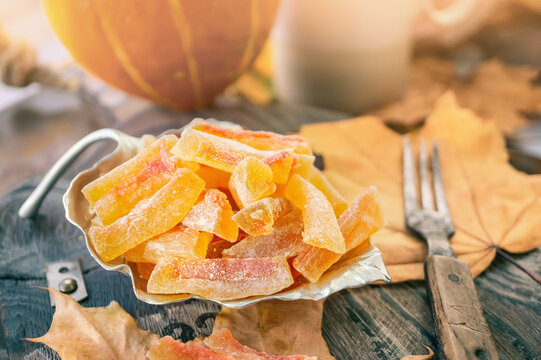 Preparation of natural farm homemade candied pumpkin fruits sprinkled with powdered sugar. Dried candied pumpkin fruits