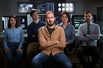 Obraz premium Serious faces confident diverse business people office workers team in row looking at camera. Caucasian professional employees executives group posing together for corporate portrait, leadership
