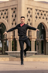 spanish flamenco dancer dressed in black turning around on himself