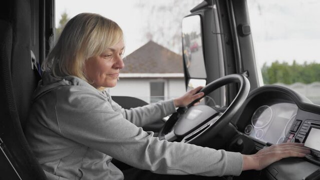 Caucasian mid age woman driving truck. trucker female worker, transport industry occupation 
