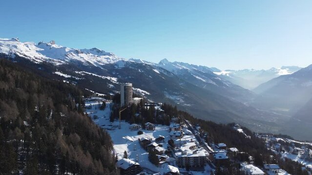 Crans Montana Ski resort, 4k drone video footage of crans montana ski resort flying through the valley of Crans Montana, Swiss Alps, Ski Resort in perfect light in the morning of fresh snow.