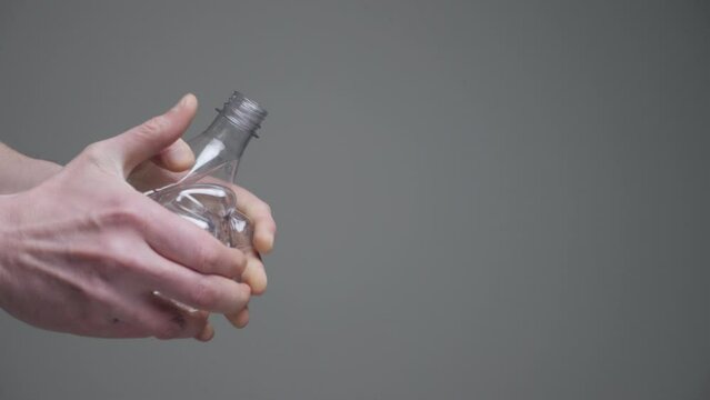 Hands twisting bottle crumpled plastic reduce concept. Crushed bottle water. Resize. Used pet. Grab hands crushed plastic bottle recycle pet plastic reduce waste materials recyclable waste management