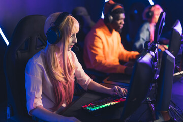 group of professional gamers playing in online video games tournament medium shot indoors esport...