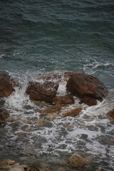 Climbing over the rocks and swimming in the crystal waters of aphrodite's beach in cyprus