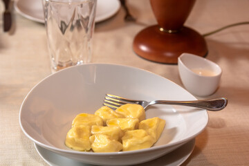 Traditional pelmeni, ravioli, dumplings filled with meat on plate, russian kitchen