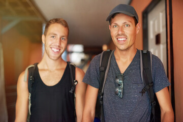 Travel partners and best buddies. Portrait of two smiling young friends wearing backpacks traveling together in Thailand.