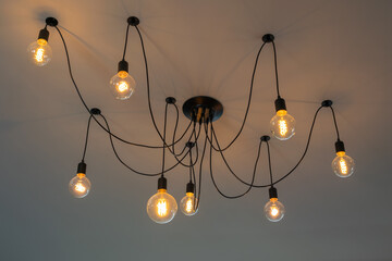 Set of retro Tungsten Edison ceiling lamps light bulbs decorated on gray cement background interior...