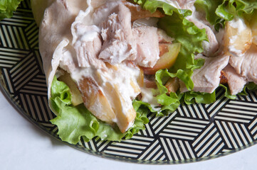 shawarma chicken with lettuce, french fries, onion and garlic