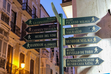 Signpost in the City Centre with directions to tourist attractions.In the evening hours.Malaga,...