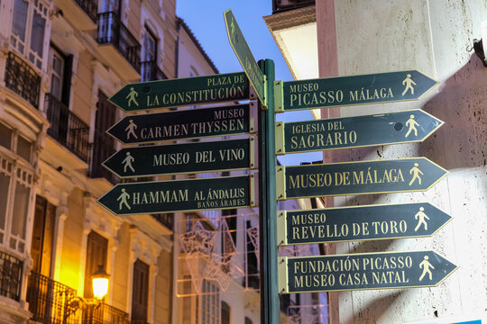 Signpost in the City Centre with directions to tourist attractions.In the evening hours.Malaga, Spain, Andalusia.
