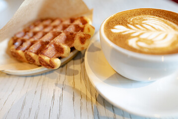 cup of cappuccino and waffle