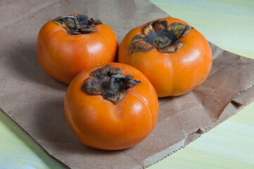 three delicious caquis on the table