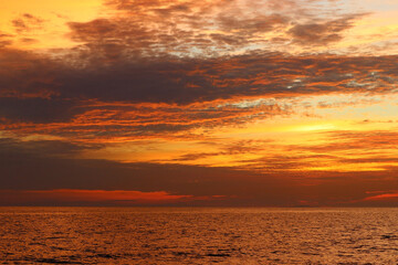 Naklejka na ściany i meble peaceful ocean with beautiful sunset background