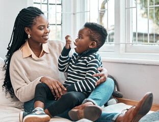 Just like that.... Shot of a little boy using his inhaler while sitting at home with his mother.