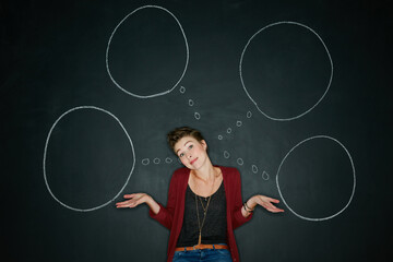 I have no idea what Im doing. Studio shot of a young woman posing with a chalk illustration of...