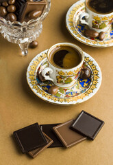Traditional Turkish Coffee on brown kraft paper surface with madlen chocolates.Conceptual image for celebrations.