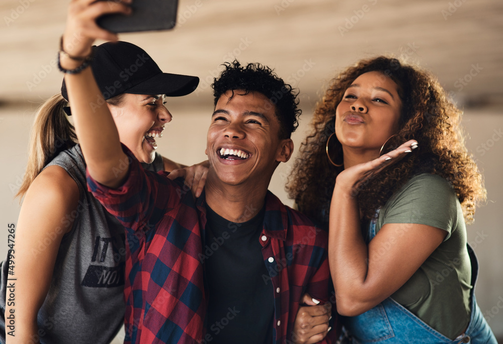 Poster smile for the camera my friends. portrait of a group of cheerful young friends posing for a self por