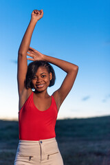 Vertical portrait of a young black woman posing