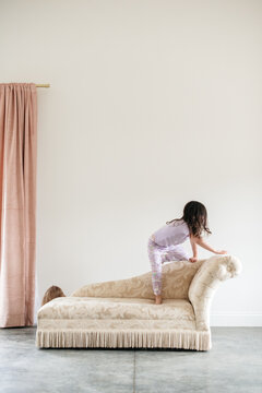 Child Climbing On Couch