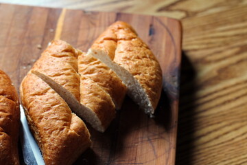 wheat bolillos placed on a wooden table. Flat-lay photo.