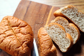 wheat bolillos placed on a wooden table. Flat-lay photo.
