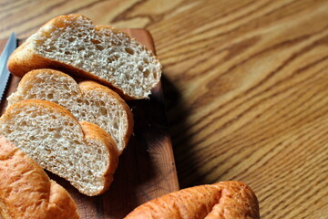 wheat bolillos placed on a wooden table. Flat-lay photo.