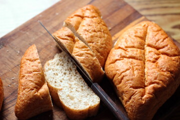 Baked bread placed on a wooden table. Flat-lat photo.