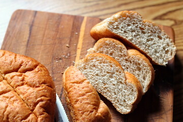 wheat bolillos placed on a wooden table. Flat-lay photo.
