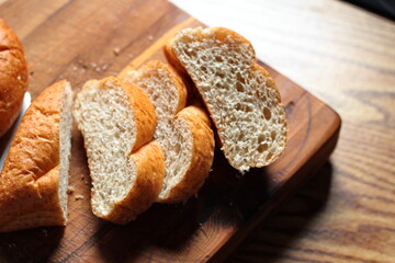 wheat bolillos placed on a wooden table. Flat-lay photo.