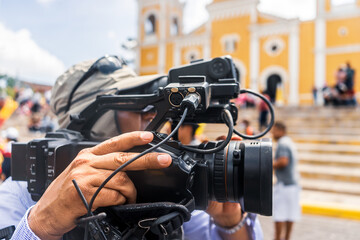 Fototapeta premium An unrecognizable cameraman films footage of a religious activity in Nicaragua during Holy Week