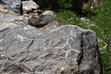 Ancient Petroglyphs etched into rock at White Tank Regional Park in Arizona